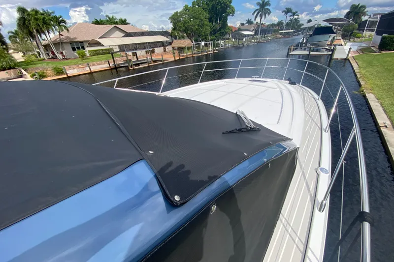  Yacht Photos Pics Azimut Atlantis 45 yacht, 2021 model, docked in a scenic canal setting.