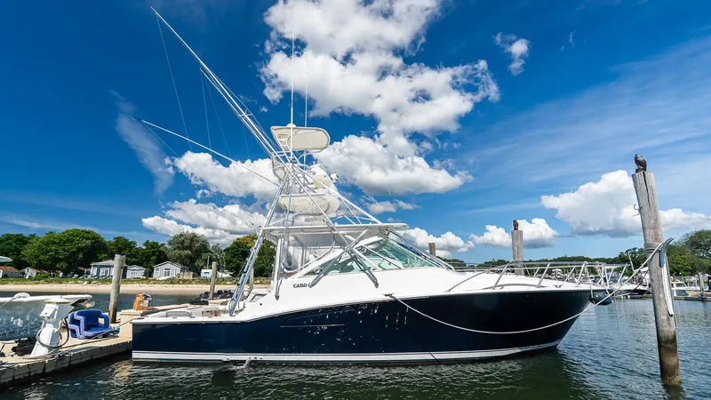  Yacht Photos Pics 2008 Cabo 38 Express boat docked under a bright blue sky with clouds.