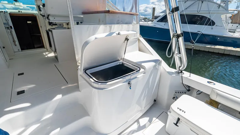  Yacht Photos Pics 2008 Cabo 38 Express boat interior with open storage compartment and Yeti cooler.