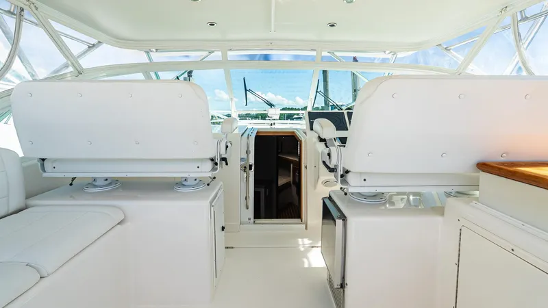  Yacht Photos Pics 2008 Cabo 38 Express yacht interior with white seating and helm station.