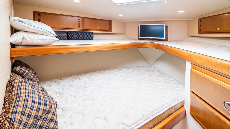  Yacht Photos Pics 2008 Cabo 38 Express cabin with cozy bunk beds and wooden storage cabinets.
