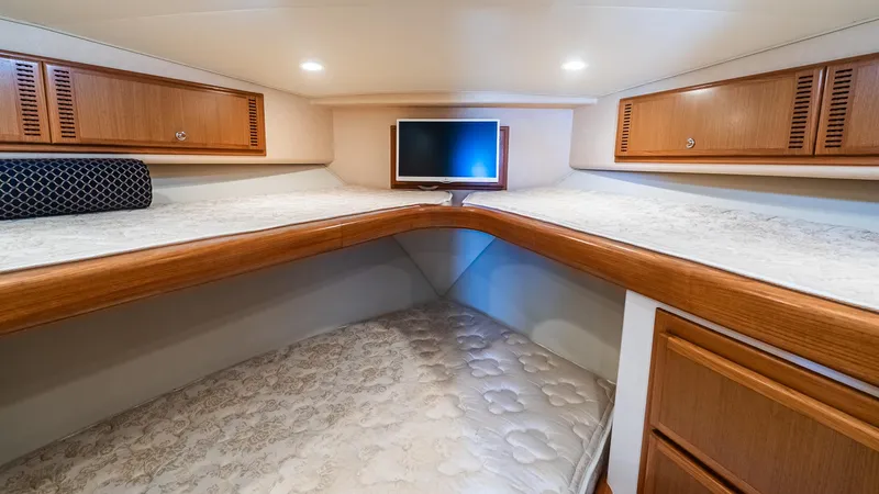  Yacht Photos Pics 2008 Cabo 38 Express cabin with twin beds, wooden cabinets, and a small TV.