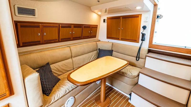  Yacht Photos Pics Interior of 2008 Cabo 38 Express yacht with beige seating and wooden cabinetry.