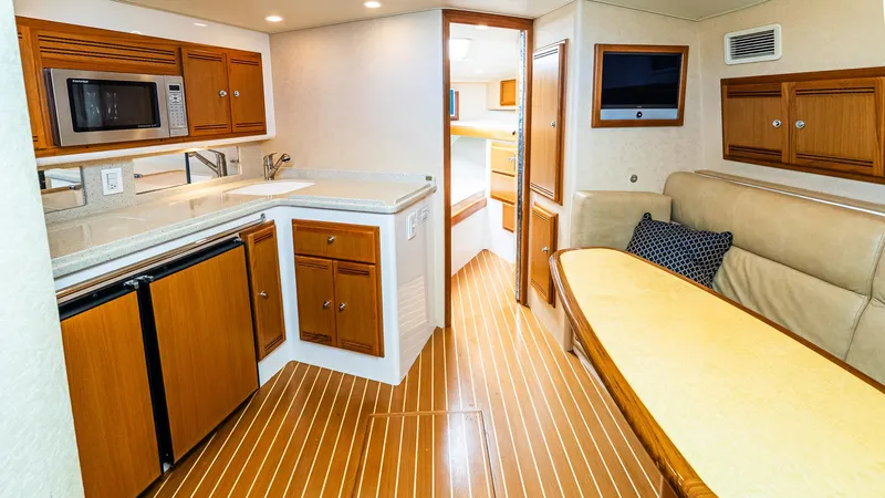  Yacht Photos Pics Luxurious 2008 Cabo 38 Express yacht interior with kitchenette and seating area.