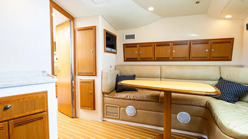  Yacht Photos Pics Interior of 2008 Cabo 38 Express yacht with beige seating and wooden cabinetry.