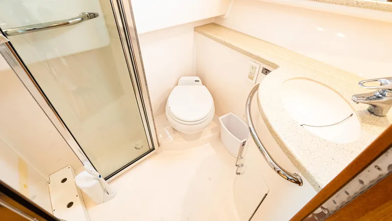  Yacht Photos Pics 2008 Cabo 38 Express bathroom with shower, toilet, and sink.