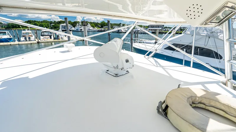  Yacht Photos Pics 2008 Cabo 38 Express yacht deck with marina view, featuring a life ring and radar equipment.