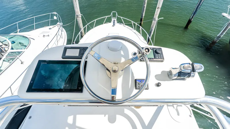  Yacht Photos Pics Helm of 2008 Cabo 38 Express yacht with navigation equipment and steering wheel.