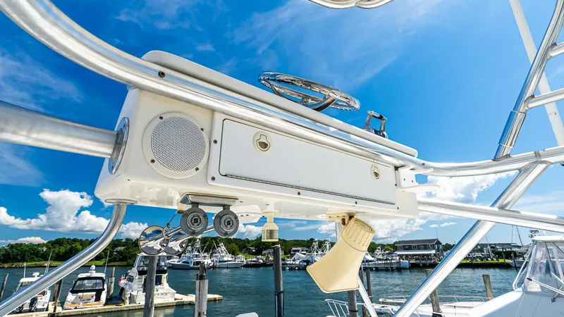  Yacht Photos Pics 2008 Cabo 38 Express boat helm with marina background under clear blue sky.