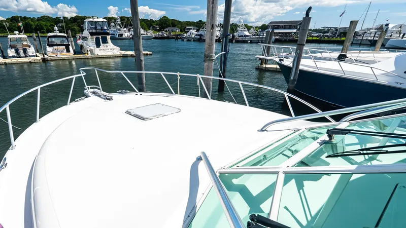  Yacht Photos Pics 2008 Cabo 38 Express yacht docked at a marina, surrounded by other boats.