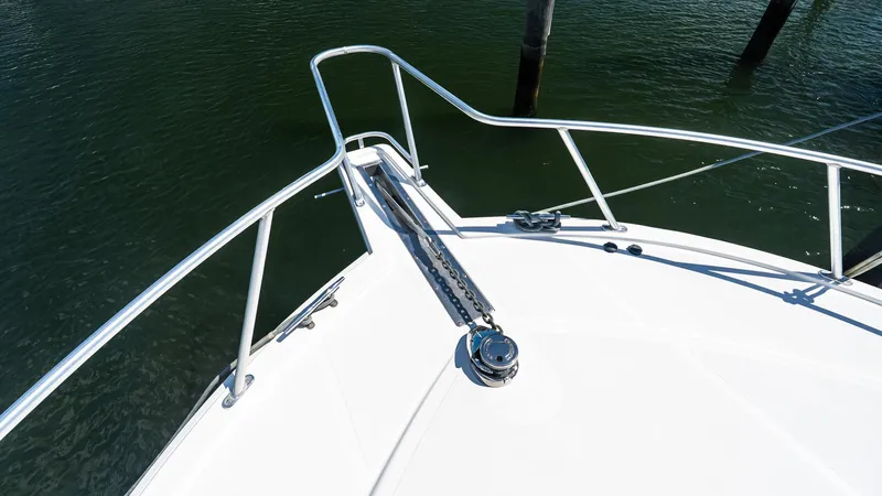 Yacht Photos Pics Bow of 2008 Cabo 38 Express yacht with anchor chain and railing.