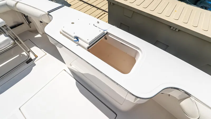  Yacht Photos Pics 2008 Cabo 38 Express boat deck with storage compartment and seating area.