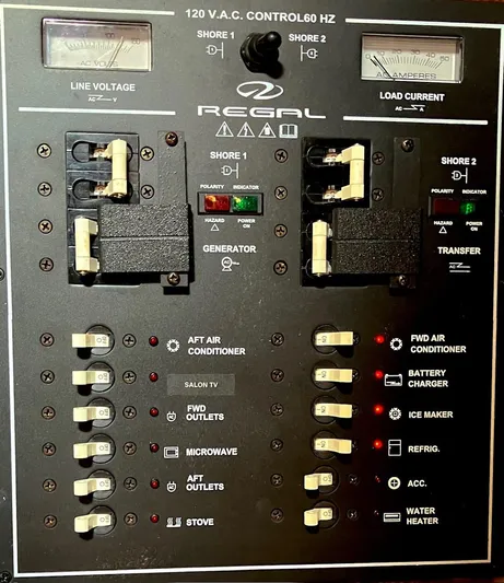 Sapphire Yacht Photos Pics Control panel of a 2014 Regal 38 Express boat, showing electrical switches and indicators.