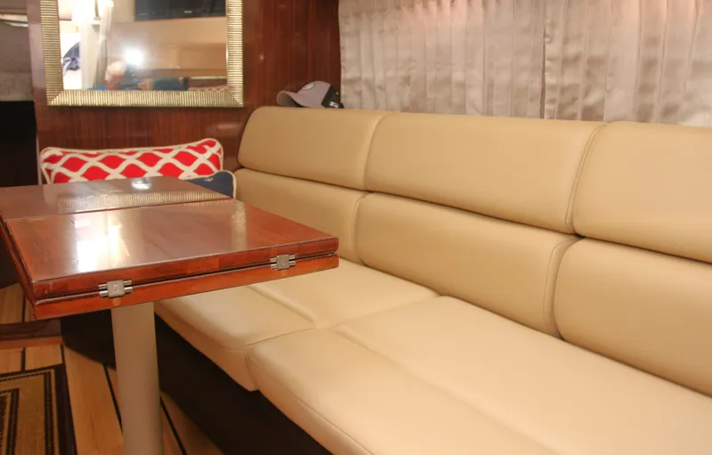 Sapphire Yacht Photos Pics Interior of 2014 Regal 38 Express yacht with beige seating and wooden table.