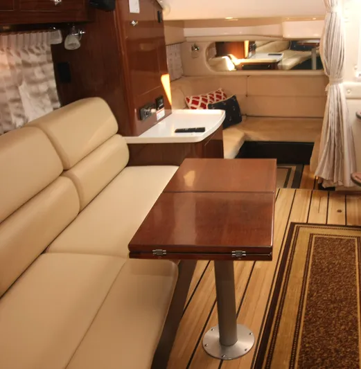 Sapphire Yacht Photos Pics Interior of 2014 Regal 38 Express yacht with beige seating and wooden table.