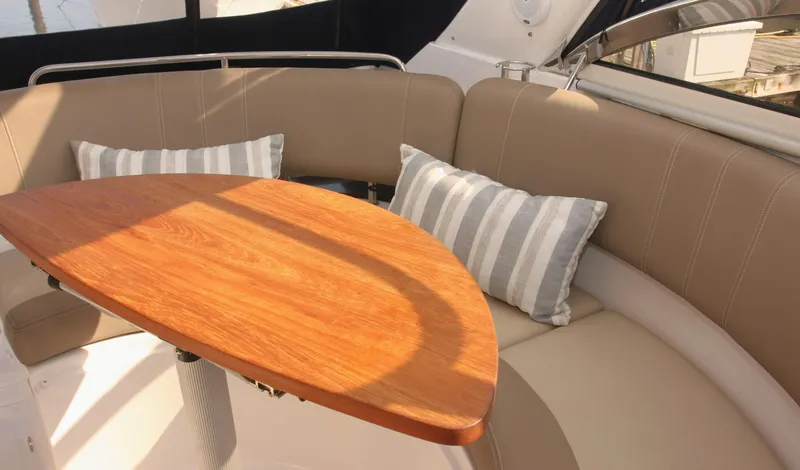 Sapphire Yacht Photos Pics 2014 Regal 38 Express yacht interior with cushioned seating and wooden table.