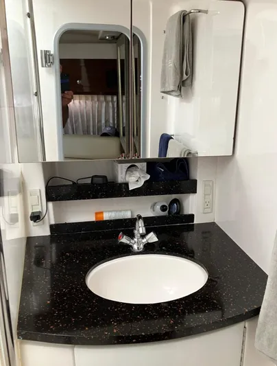 Sapphire Yacht Photos Pics 2014 Regal 38 Express bathroom with sleek black countertop and modern fixtures.