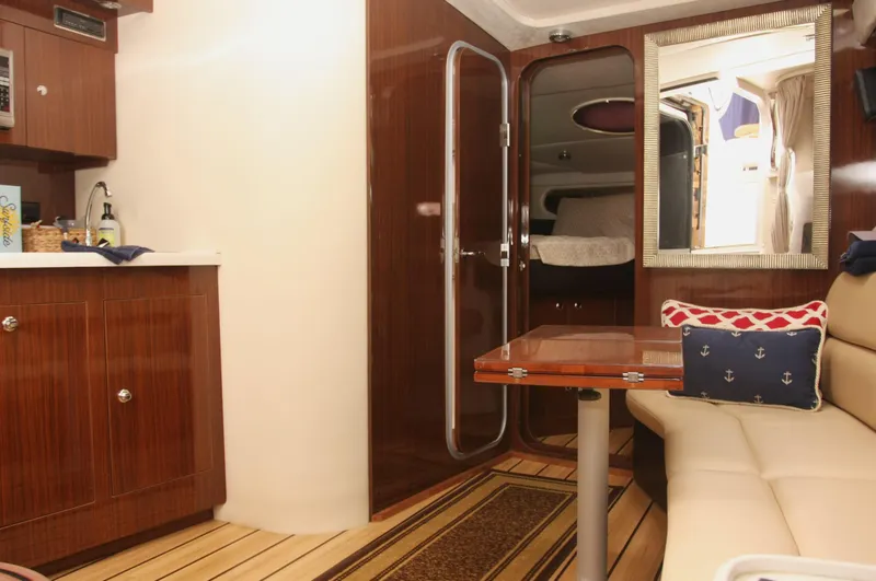 Sapphire Yacht Photos Pics 2014 Regal 38 Express yacht interior with wood finish, cozy seating, and nautical decor.