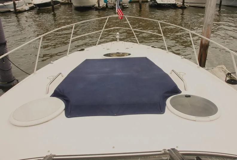 Sapphire Yacht Photos Pics 2014 Regal 38 Express yacht bow with blue cover, docked at marina.