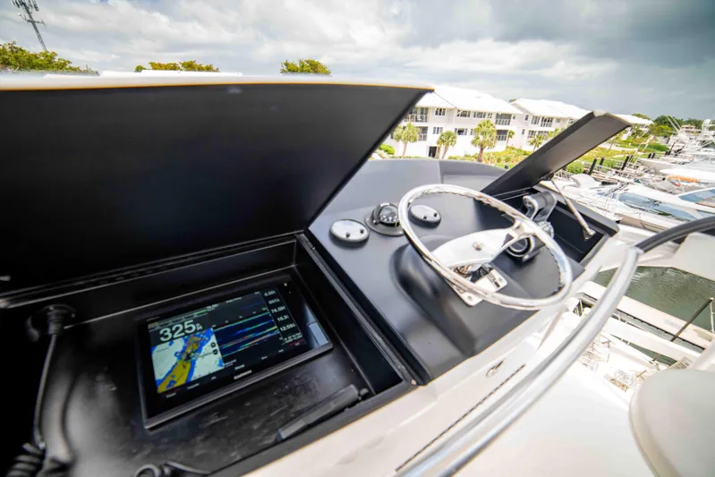 Reely Dude Yacht Photos Pics 2019 Viking 72 Enclosed Bridge yacht helm with navigation display and steering wheel.
