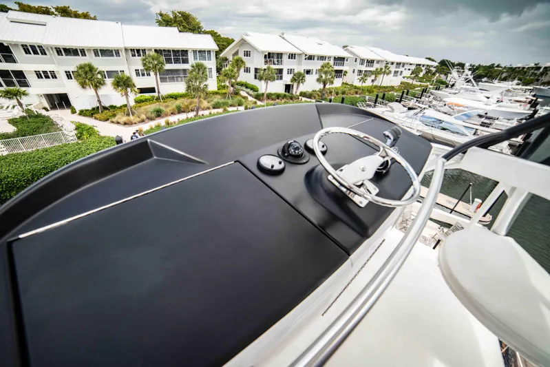 Reely Dude Yacht Photos Pics 2019 Viking 72 Enclosed Bridge yacht helm with marina and waterfront view.