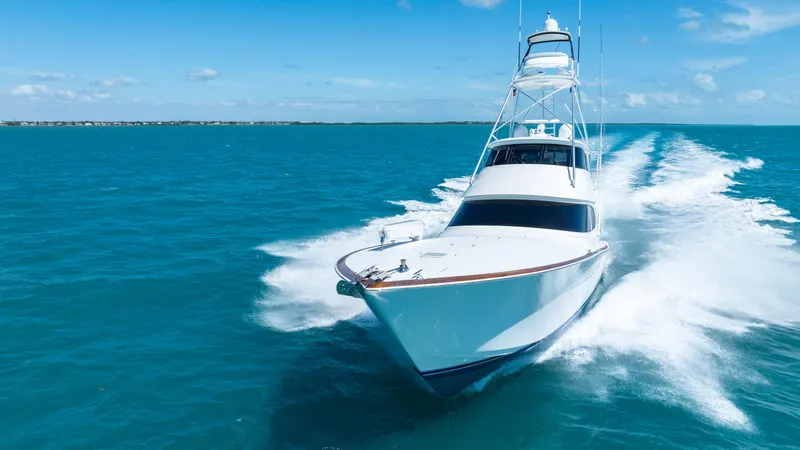 Reely Dude Yacht Photos Pics 2019 Viking 72 Enclosed Bridge yacht cruising on open blue waters.