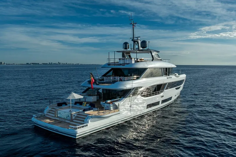 King's Lair Yacht Photos Pics Luxurious 2023 Benetti 34M OASIS yacht cruising on open sea under clear skies.
