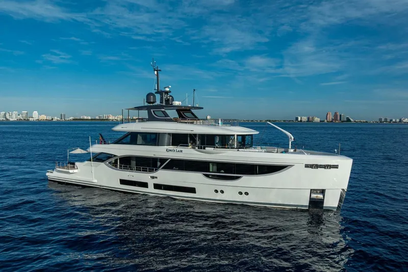 King's Lair Yacht Photos Pics Luxury 2023 Benetti 34M OASIS yacht cruising on open water under clear skies.