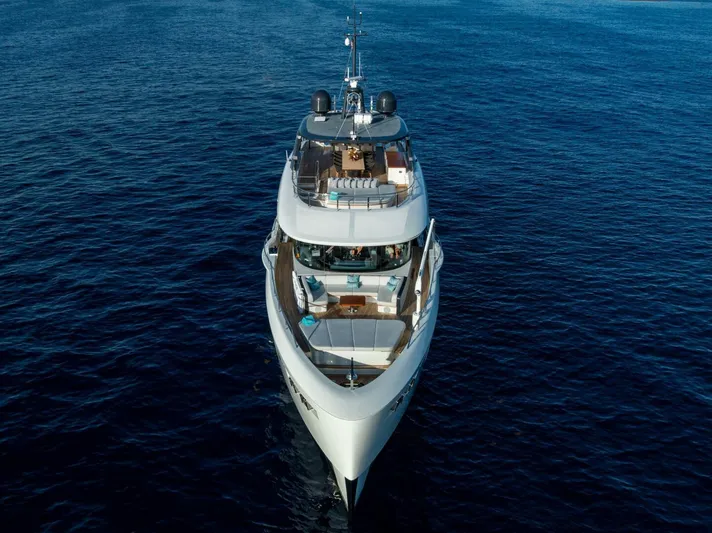 King's Lair Yacht Photos Pics Luxurious 2023 Benetti 34M OASIS yacht cruising on open sea.