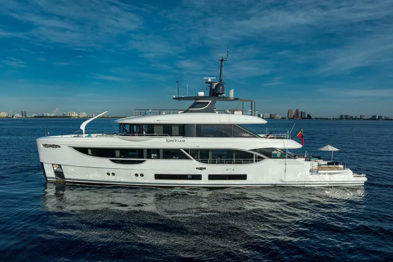 King's Lair Yacht Photos Pics Luxury 2023 Benetti 34M OASIS yacht cruising on open water under clear skies.