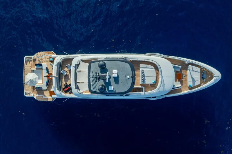 King's Lair Yacht Photos Pics Aerial view of 2023 Benetti 34M OASIS yacht on deep blue water.