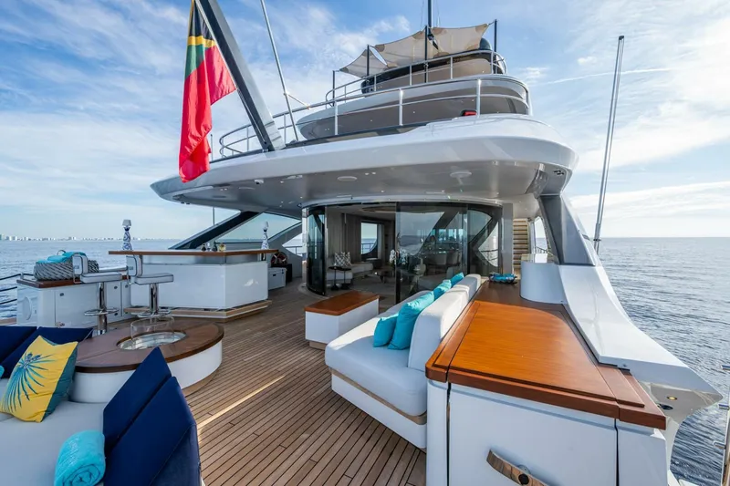 King's Lair Yacht Photos Pics Luxurious 2023 Benetti 34M OASIS yacht deck with elegant seating and ocean view.