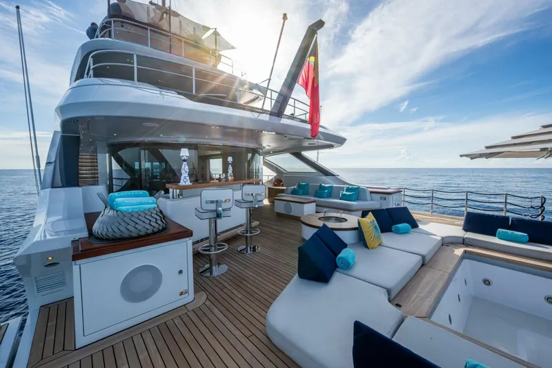 King's Lair Yacht Photos Pics Luxurious 2023 Benetti 34M OASIS yacht deck with elegant seating and ocean view.