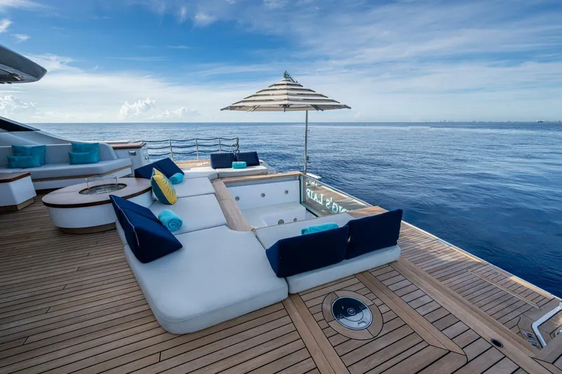 King's Lair Yacht Photos Pics Luxurious deck of 2023 Benetti 34M OASIS yacht with ocean view and seating area.