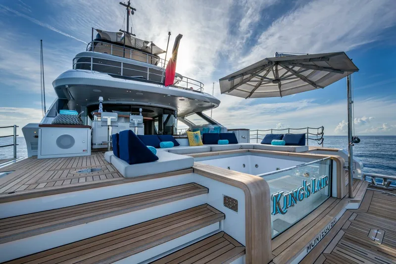 King's Lair Yacht Photos Pics Luxurious 2023 Benetti 34M OASIS yacht deck with jacuzzi and seating area.