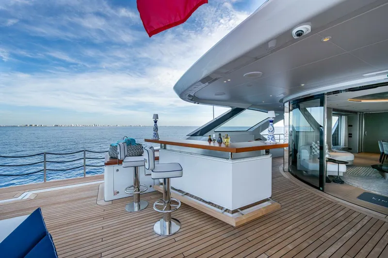 King's Lair Yacht Photos Pics Luxurious 2023 Benetti 34M OASIS yacht deck with bar and ocean view.