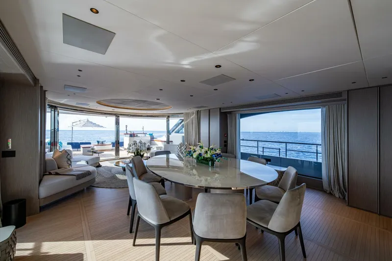 King's Lair Yacht Photos Pics Luxurious interior of 2023 Benetti 34M OASIS yacht with ocean view and elegant dining area.