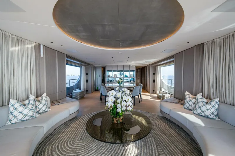 King's Lair Yacht Photos Pics Luxurious interior of 2023 Benetti 34M OASIS yacht with elegant seating and floral centerpiece.