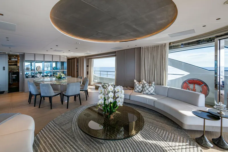 King's Lair Yacht Photos Pics Luxurious interior of 2023 Benetti 34M OASIS yacht with elegant seating and ocean view.