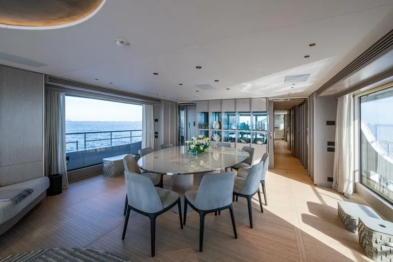 King's Lair Yacht Photos Pics Luxurious interior of 2023 Benetti 34M OASIS yacht with ocean view and elegant dining area.