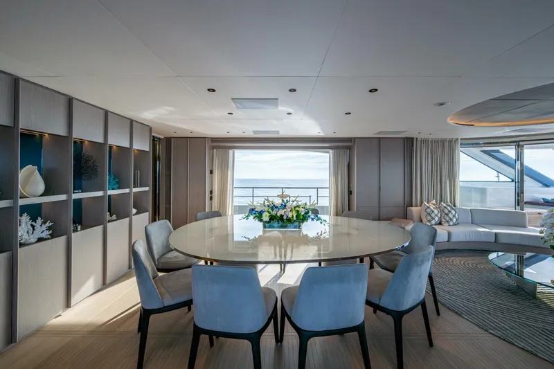 King's Lair Yacht Photos Pics Luxurious interior of 2023 Benetti 34M OASIS yacht with elegant dining area and ocean view.