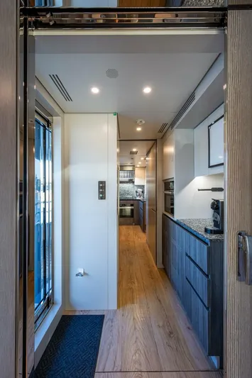 King's Lair Yacht Photos Pics Luxurious interior of 2023 Benetti 34M OASIS yacht, featuring modern kitchen design.