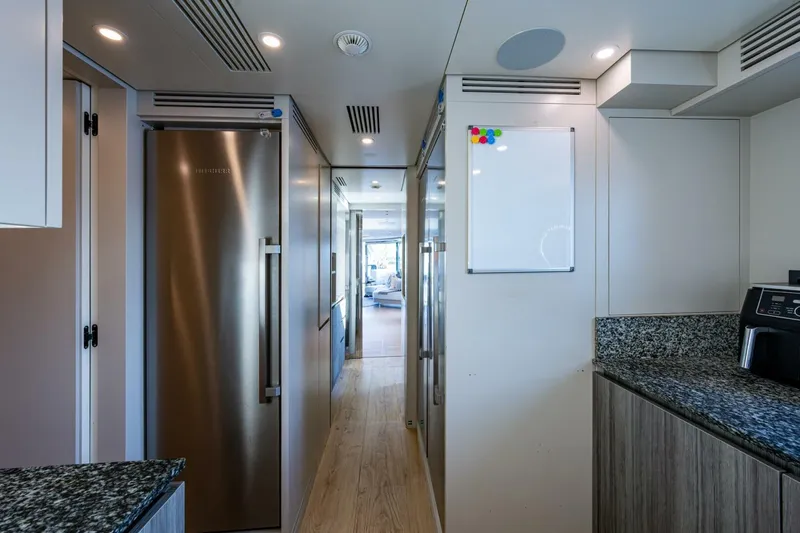 King's Lair Yacht Photos Pics Modern kitchen interior of 2023 Benetti 34M OASIS yacht with stainless steel appliances.