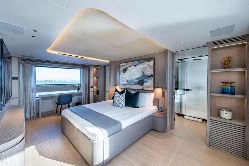 King's Lair Yacht Photos Pics Luxurious bedroom interior of 2023 Benetti 34M OASIS yacht with modern decor and ocean view.
