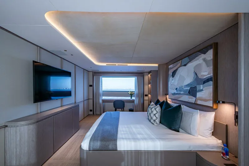 King's Lair Yacht Photos Pics Luxurious bedroom interior of 2023 Benetti 34M OASIS yacht with modern decor and ocean view.