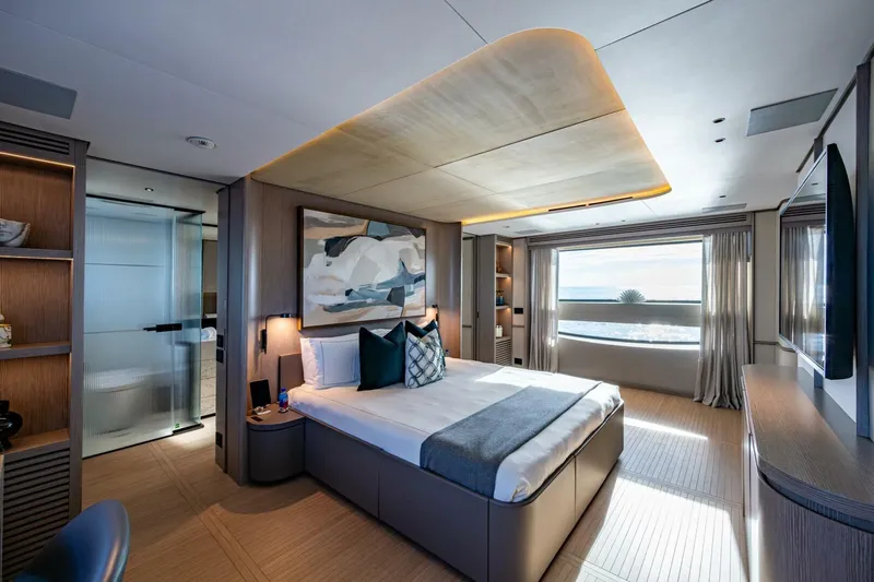 King's Lair Yacht Photos Pics Luxurious bedroom interior of 2023 Benetti 34M OASIS yacht with ocean view.