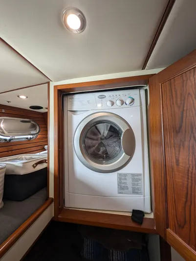 Good Job Yacht Photos Pics Laundry area inside a 2002 Nordhavn Trawler, featuring a built-in washing machine.
