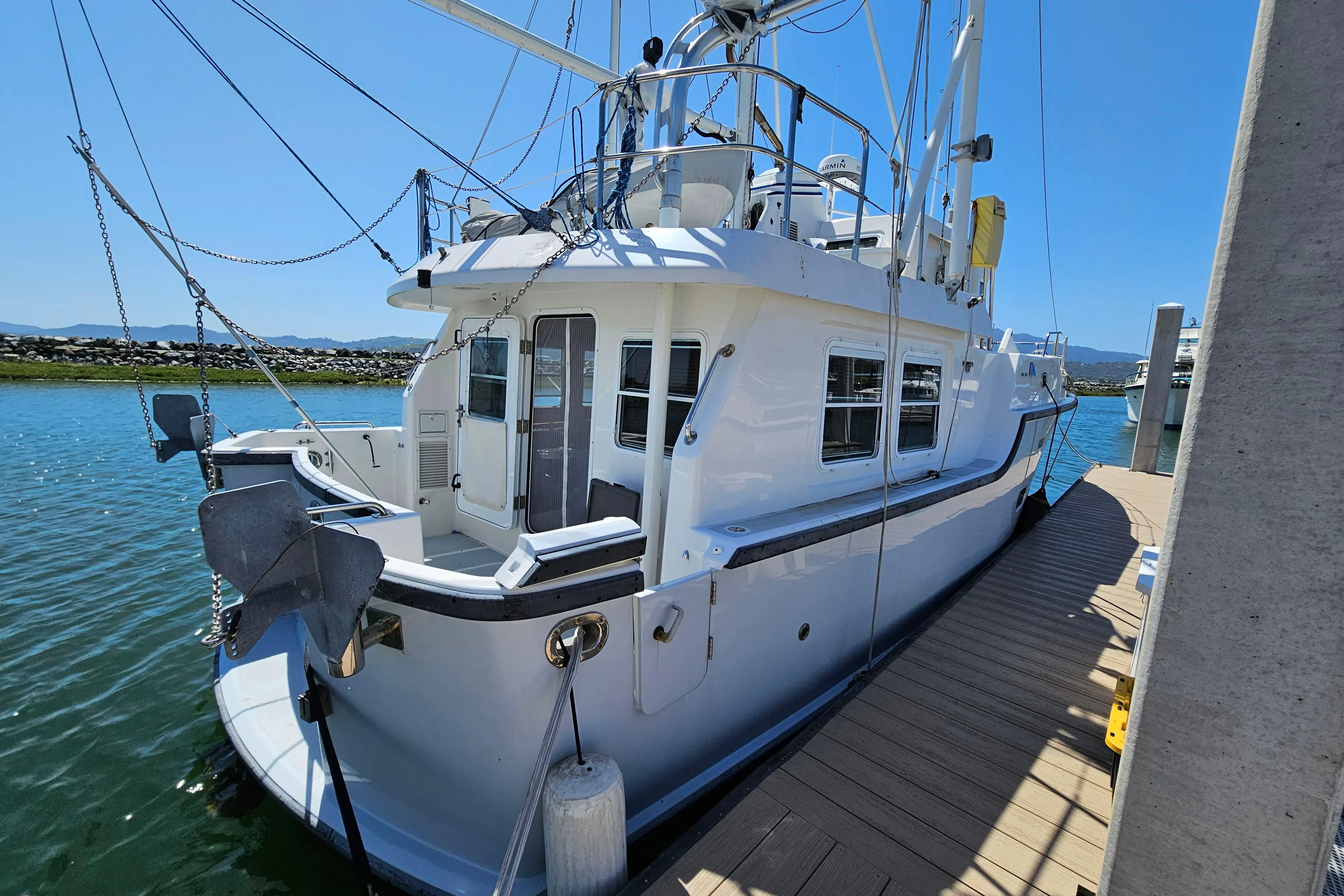 2002 Nordhavn Trawler docked, showcasing its sturdy design and spacious deck.
