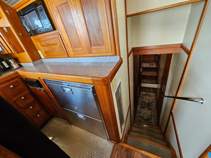 Good Job Yacht Photos Pics Interior of 2002 Nordhavn Trawler with wooden cabinetry and stairs leading below deck.