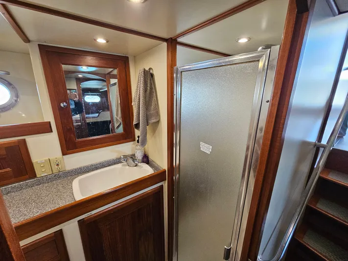 Good Job Yacht Photos Pics Bathroom interior of a 2002 Nordhavn Trawler with shower, sink, and mirror.